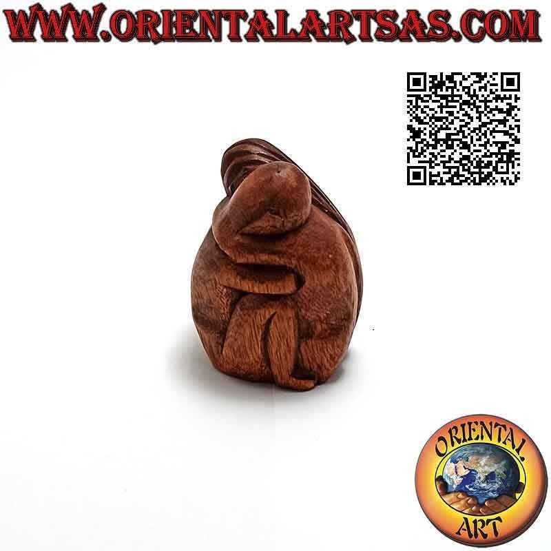 7.5 cm sculpture of a couple in consoling embrace in suar wood