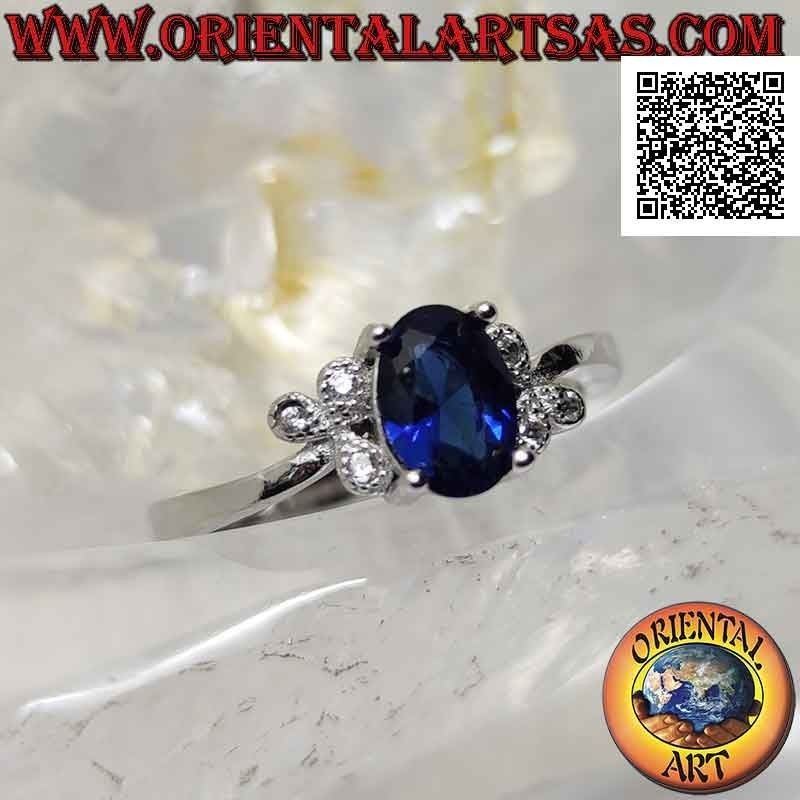 Bague en argent avec saphir synthétique ovale serti et trois zircons blancs sur les côtés
