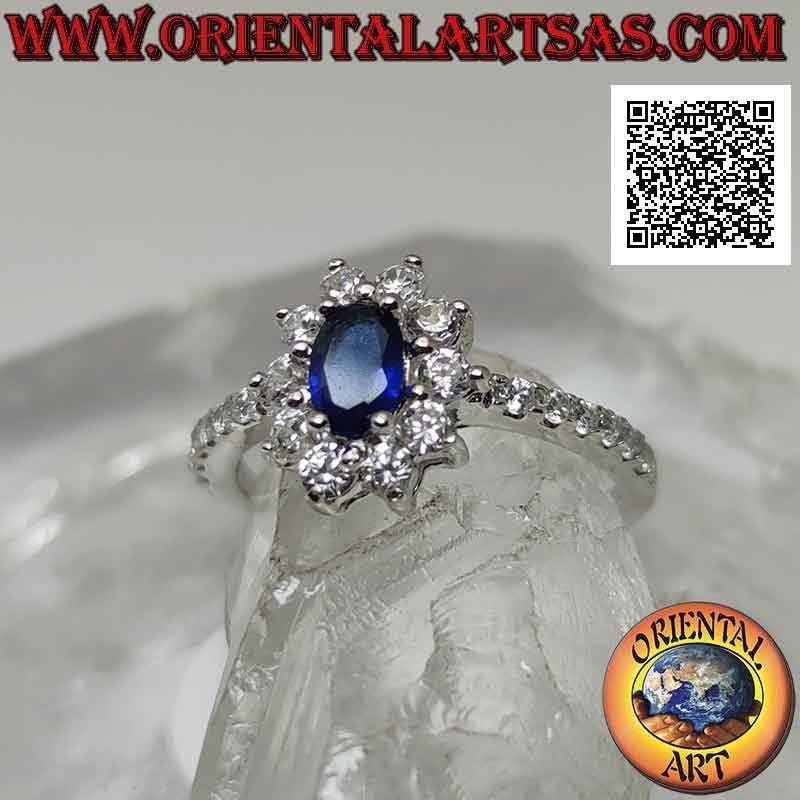 Anillo de plata con flor de circonita blanca engastada con zafiro sintético ovalado y circonita en los lados