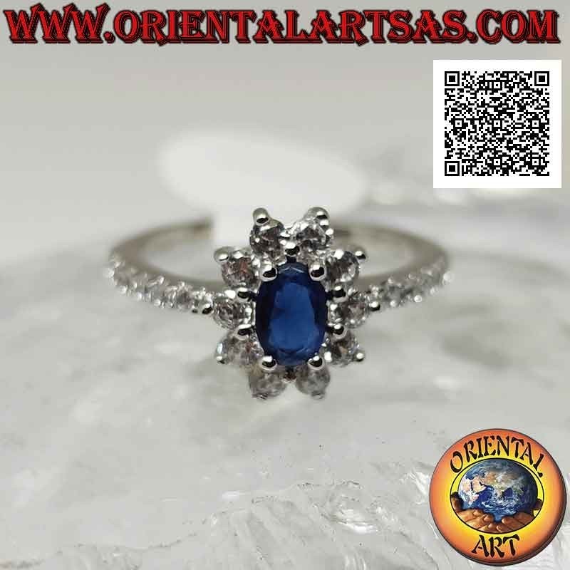 Anillo de plata con flor de circonita blanca engastada con zafiro sintético ovalado y circonita en los lados