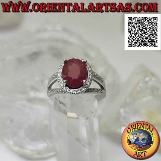 Silver ring with large oval natural ruby set surrounded by white zircons and three lines