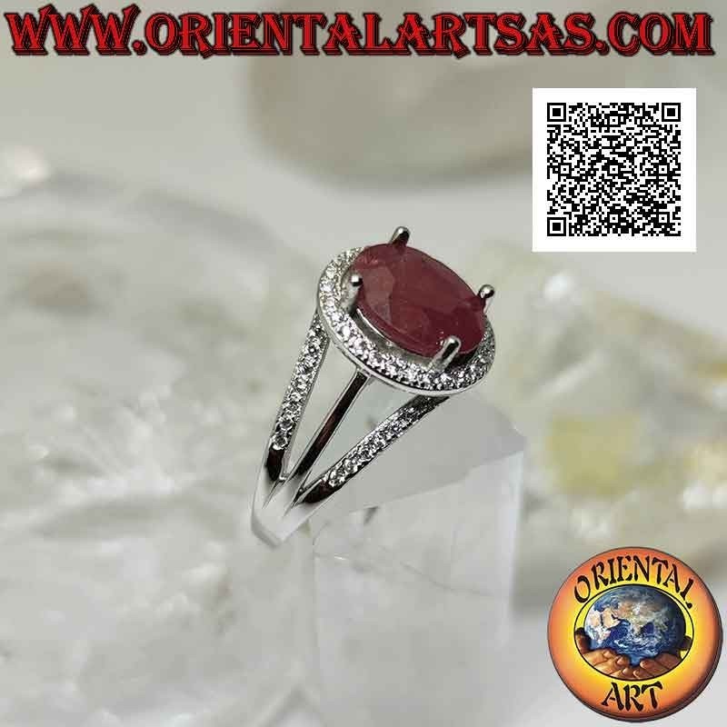 Silver ring with large oval natural ruby set surrounded by white zircons and three lines