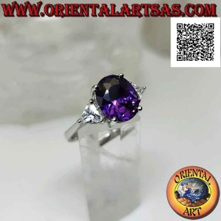 Silver ring with oval synthetic amethyst set between two triangles of white zircons