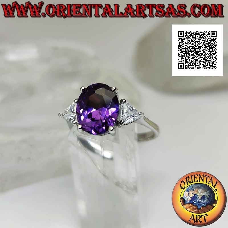 Silver ring with oval synthetic amethyst set between two triangles of white zircons