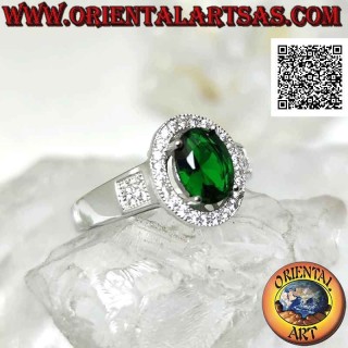 Silver ring with oval synthetic emerald set surrounded by zircons and square on the sides