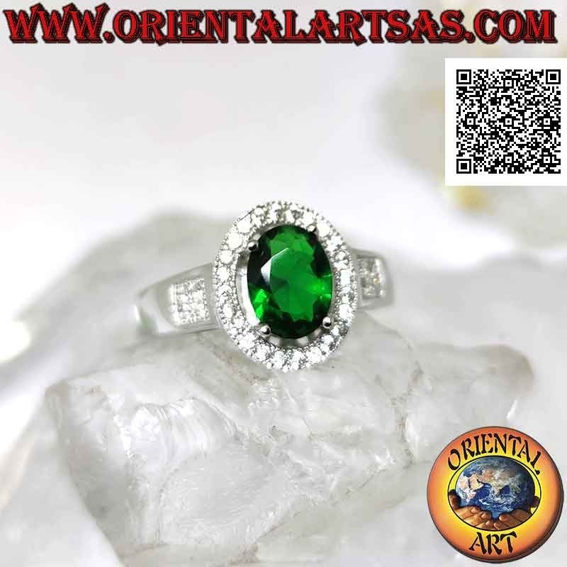 Silver ring with oval synthetic emerald set surrounded by zircons and square on the sides