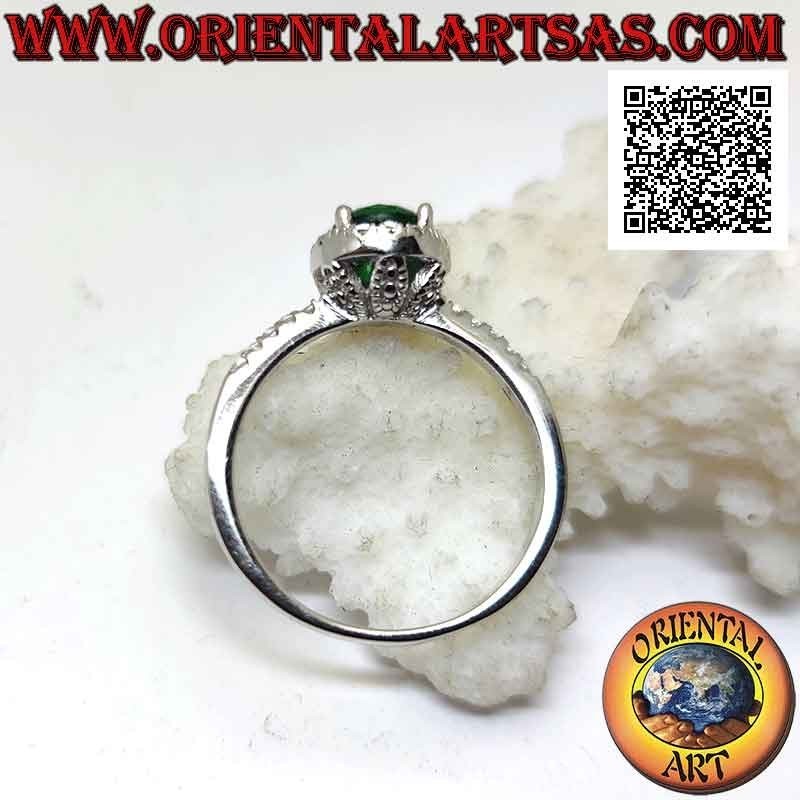 Silver ring with round synthetic emerald set surrounded by white zircons and on the sides