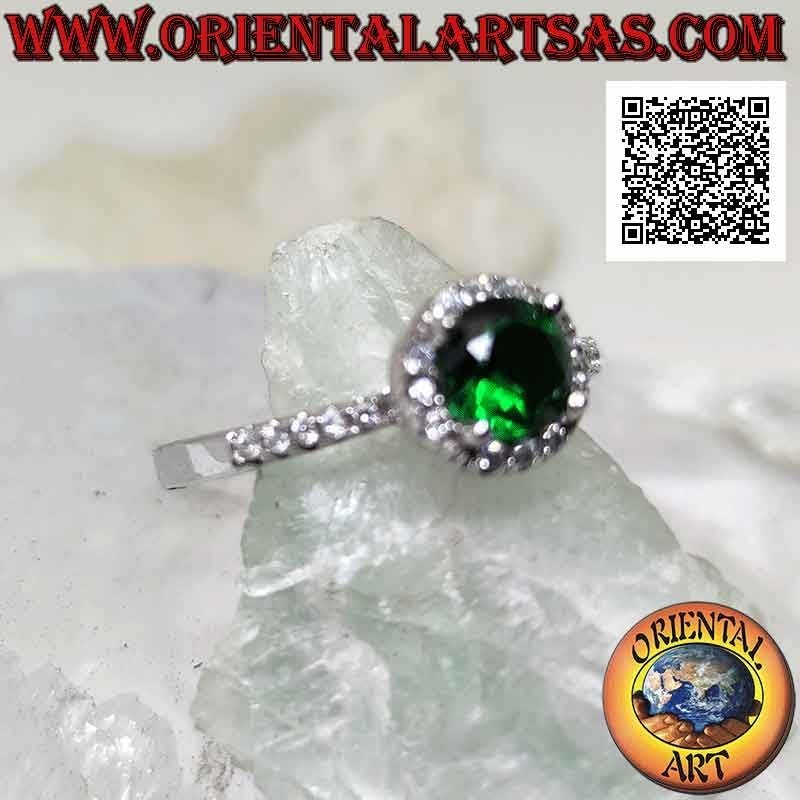 Silver ring with round synthetic emerald set surrounded by white zircons and on the sides