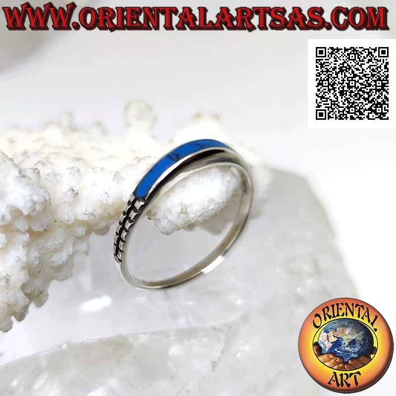 Silver ring with protruding rectangular turquoise on one side and engravings on the other
