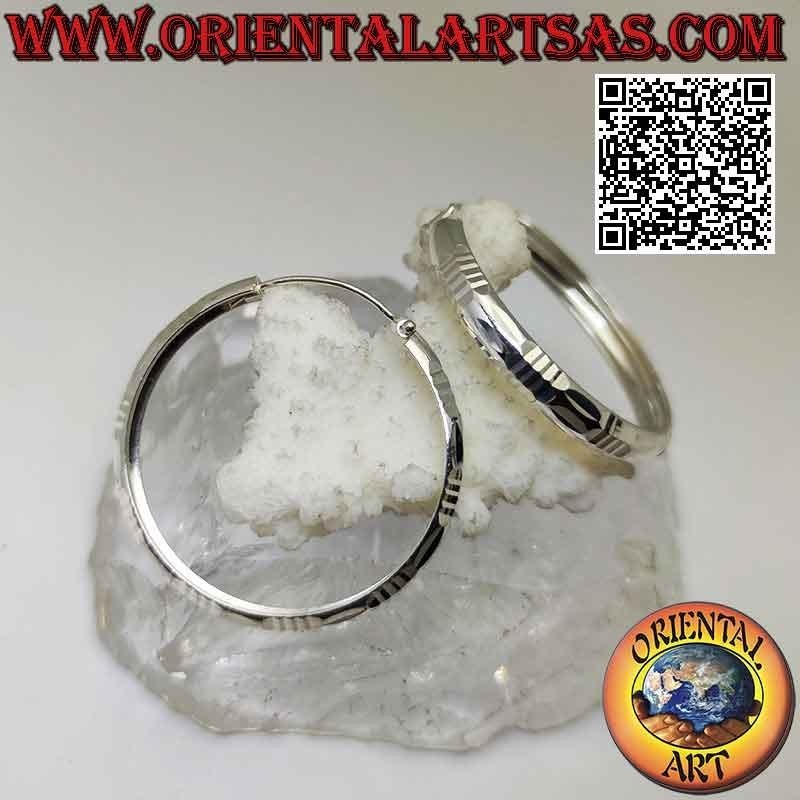 Silver baguette and horizontal 40 mm wide diamond circle earrings.