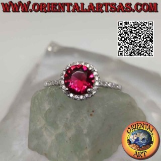Silver ring with round synthetic ruby set surrounded by zircons and extension on the sides