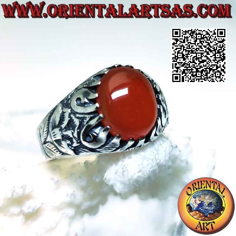Silver ring with set oval cabochon carnelian and mystical bas-relief decoration