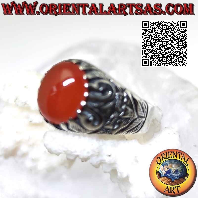Silver ring with set oval cabochon carnelian and mystical bas-relief decoration