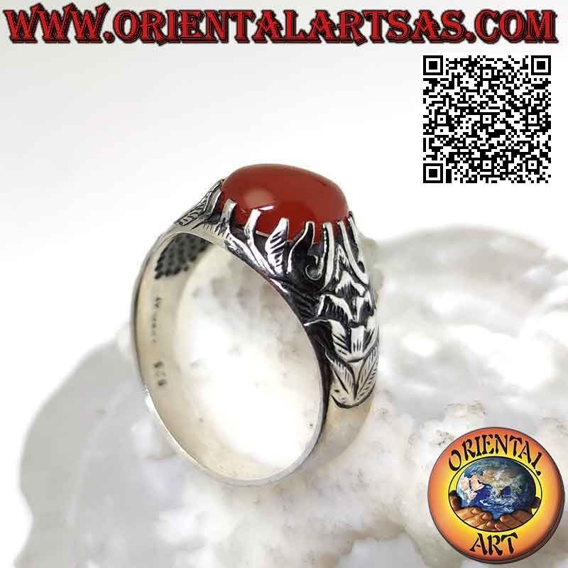 Silver ring with set oval cabochon carnelian and mystical bas-relief decoration