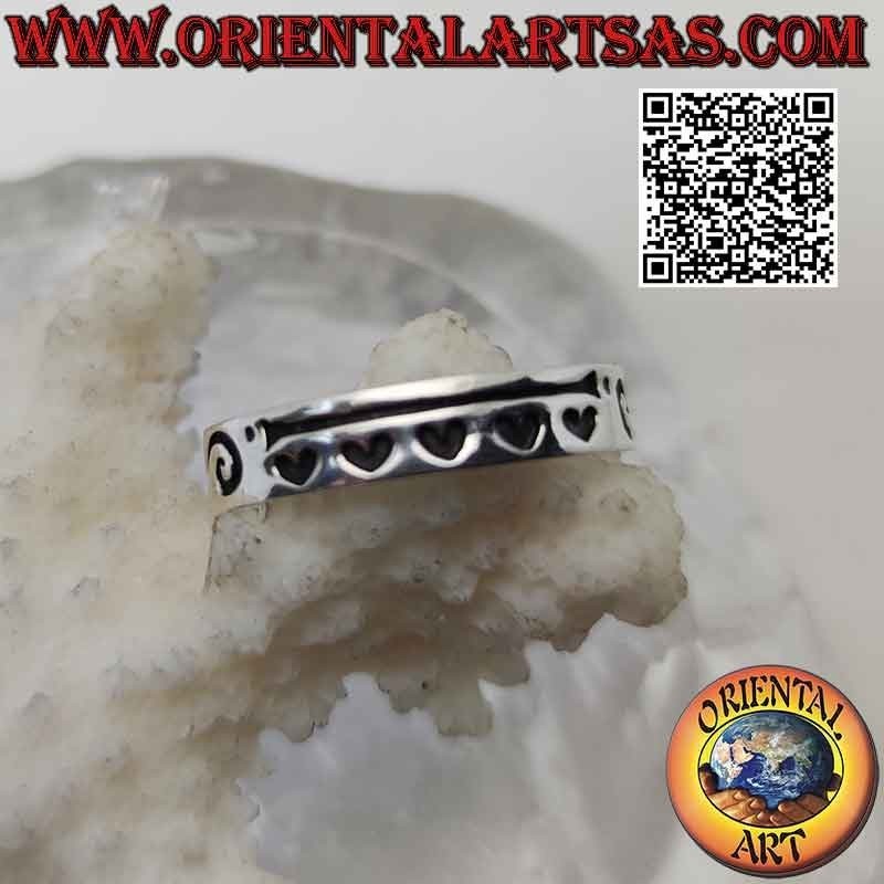 Smooth band silver ring with tribal decoration and deeply engraved hearts