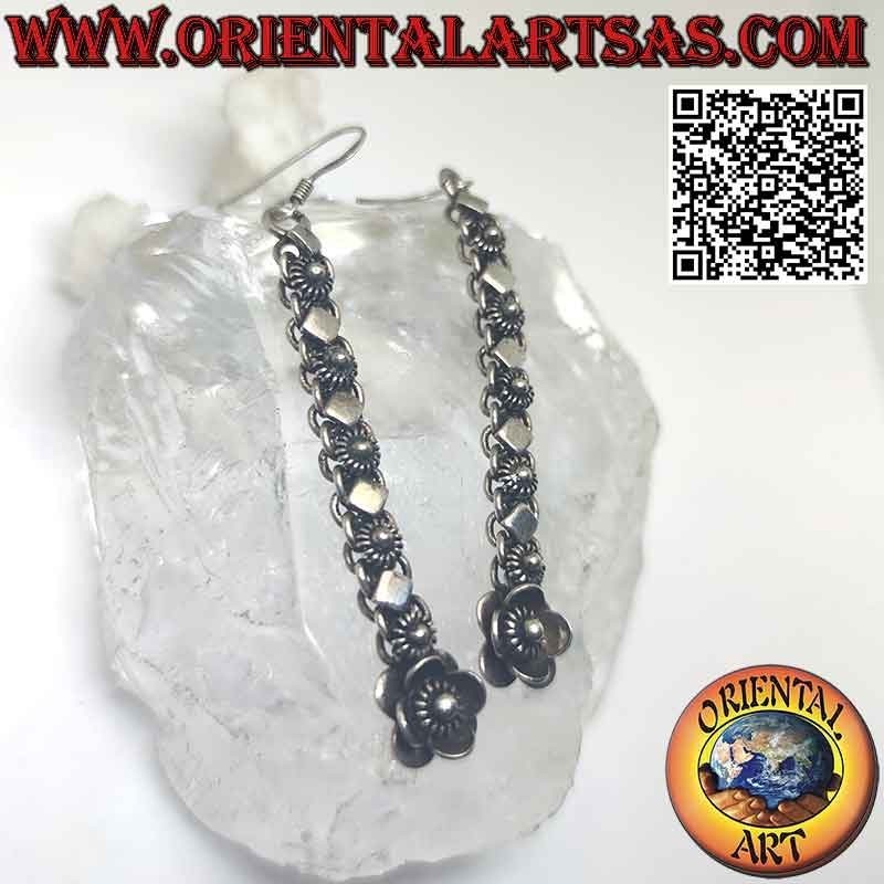 Silver earrings with a row of flowers and alternating rhomboid plates (pendants)