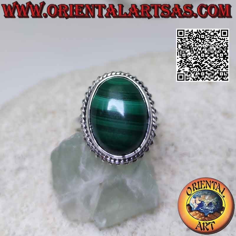 Silver ring with cabochon oval malachite (horizontal streaks) surrounded by interweaving and helical line