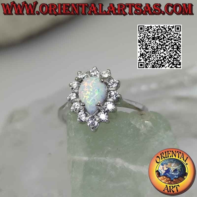 Silver ring with teardrop harlequin opal set surrounded by white zircons