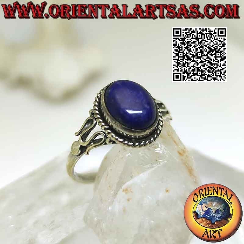 Silver ring with oval cabochon lapis lazuli surrounded by interweaving and serpentine on the sides