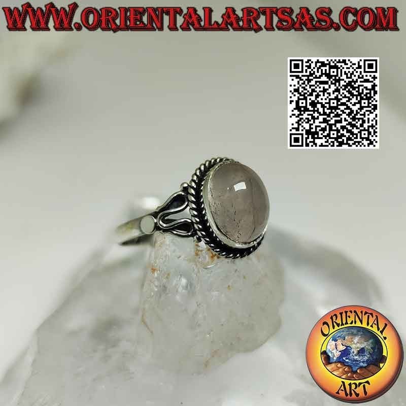 Silver ring with cabochon oval rose quartz surrounded by interweaving and serpentine on the sides
