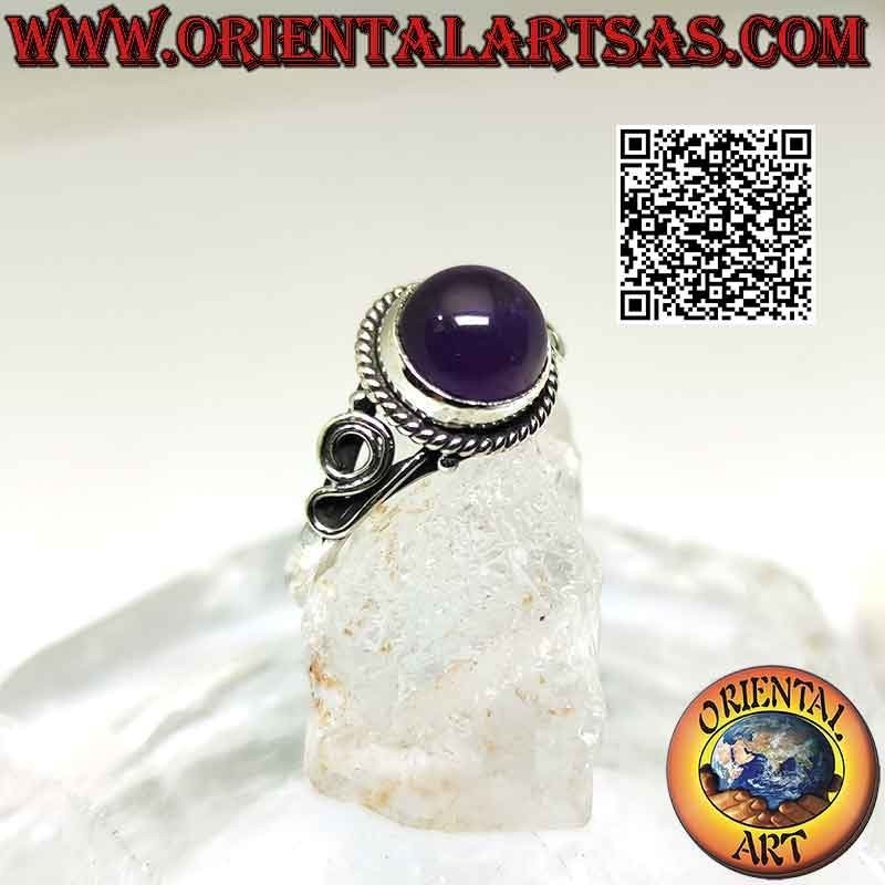 Silver ring with round cabochon amethyst surrounded by interweaving and spiral on the sides