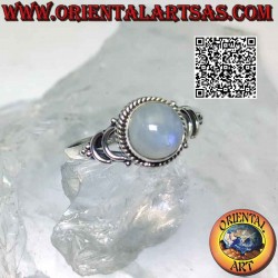 Silver ring with round cabochon rainbow moonstone surrounded by interweaving and double U hook