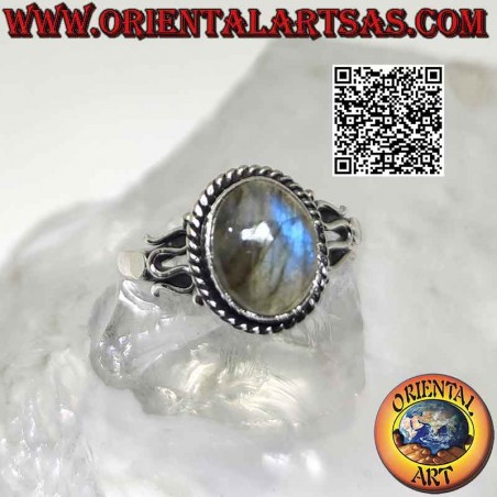 Silver ring with cabochon oval labradorite surrounded by interweaving and serpentine on the sides