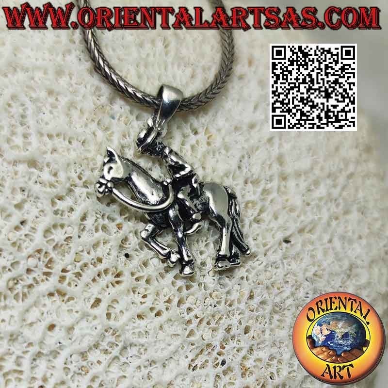 Silver pendant in the shape of a cowboy on horseback (profile)