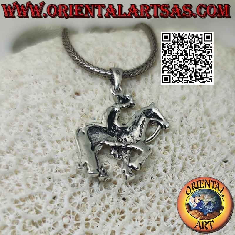 Silver pendant in the shape of a cowboy on horseback (profile)