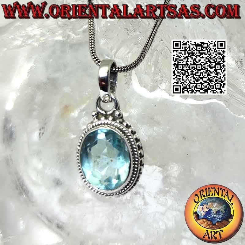 Silver pendant with oval blue topaz and intertwining and balls