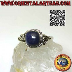 Silver ring with cabochon lapis lazuli surrounded by interweaving and asymmetrical spiral on the sides