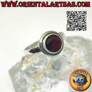 Silver ring with raised faceted round garnet with protruding smooth edge