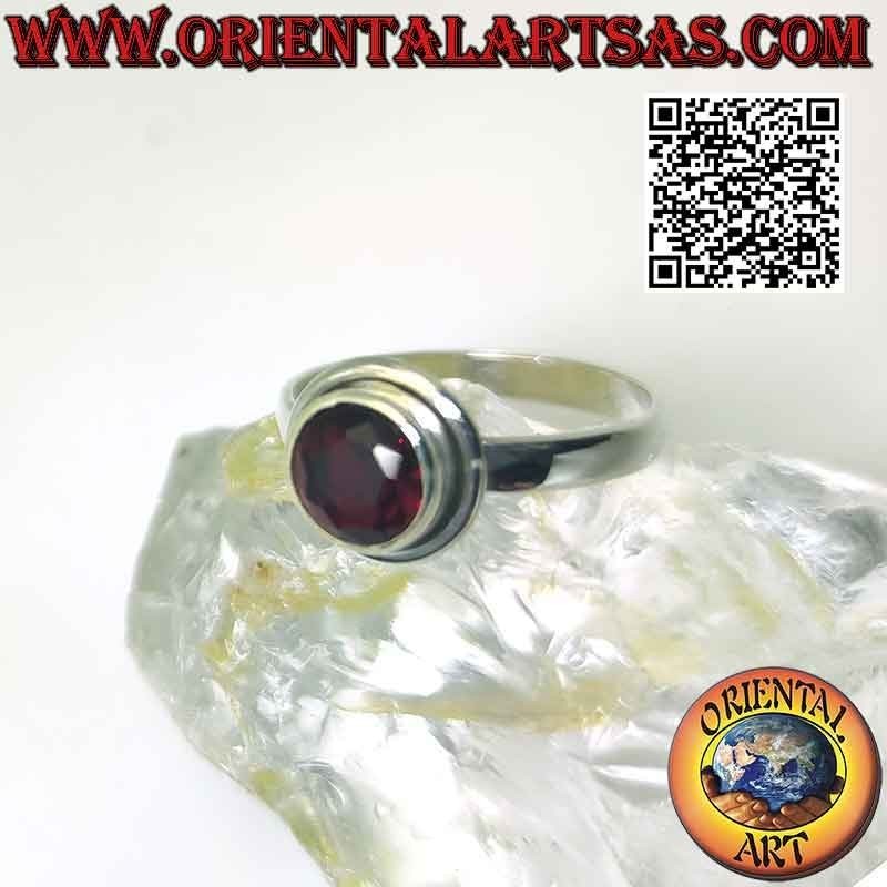 Silver ring with raised faceted round garnet