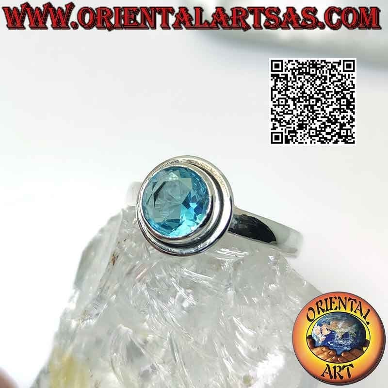 Silver ring with raised faceted round topaz and edge
