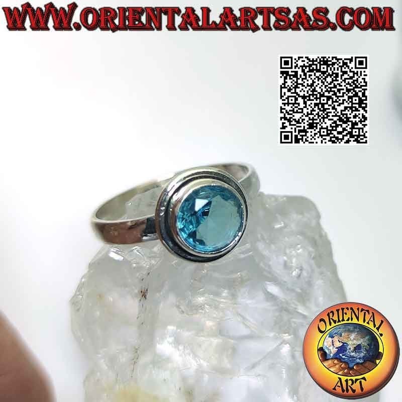Silver ring with raised faceted round topaz and edge