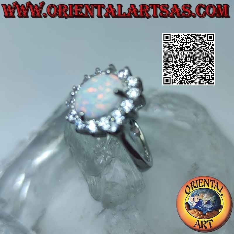 Silver ring with oval harlequin opal surrounded by zircons