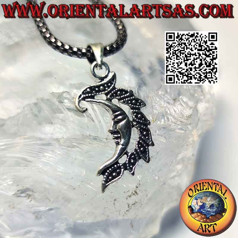 Silver pendant, smooth crescent with face and crest of leaves
