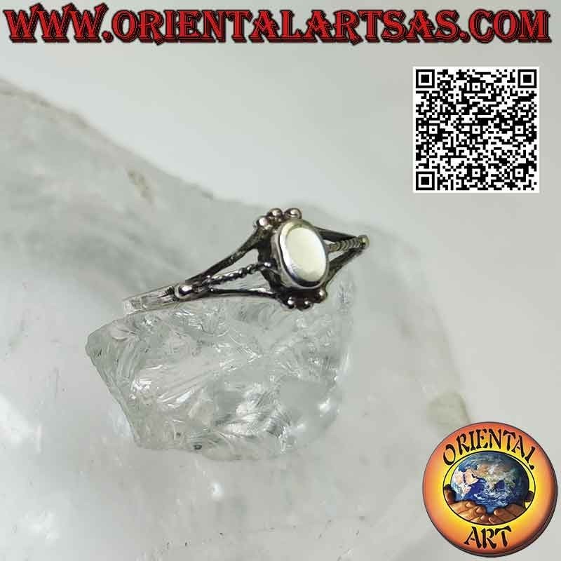 Silver ring with oval mother of pearl between trio of balls