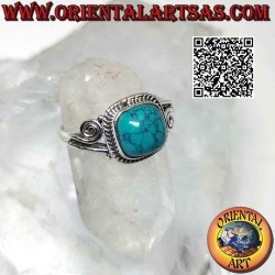 Silver ring with cabochon turquoise surrounded by interweaving and asymmetrical spiral on the sides