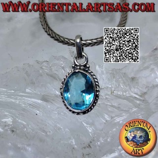Silver pendant with faceted oval blue topaz surrounded by interweaving and balls on the cardinal points