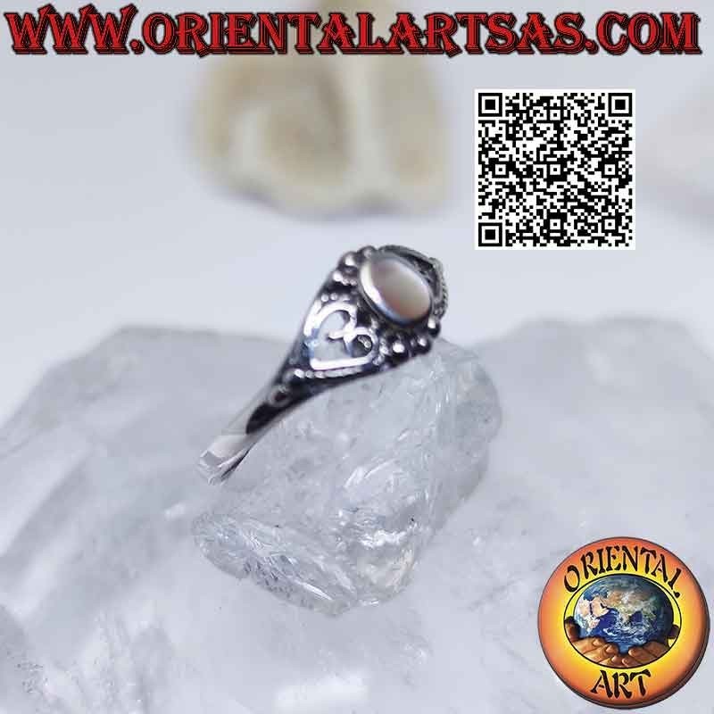Silver ring with small oval mother of pearl between pierced heart
