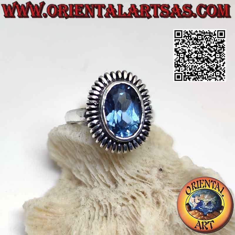 Silver ring with oval blue topaz surrounded by a smooth spring