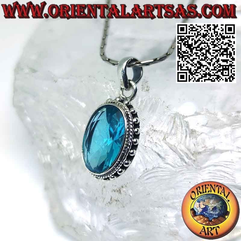 Silver pendant with faceted oval blue topaz surrounded by balls