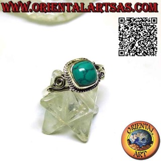 Silver ring with cabochon turquoise surrounded by intertwining and asymmetrical spiral on the sides
