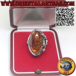 Silver ring with large oval amber and lily flower on one side