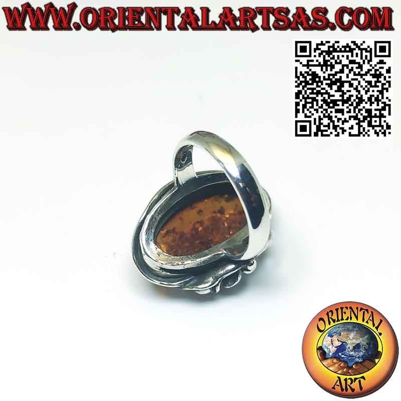 Anillo de plata con gran ámbar ovalado y flor de lirio en un lado