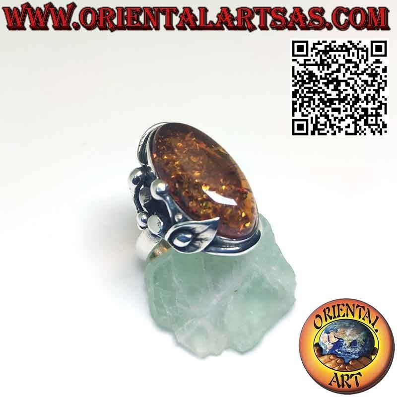 Silver ring with large oval amber and lily flower on one side