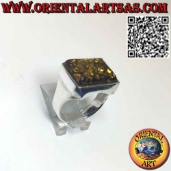 Rectangular silver ring with a large green Baltic amber