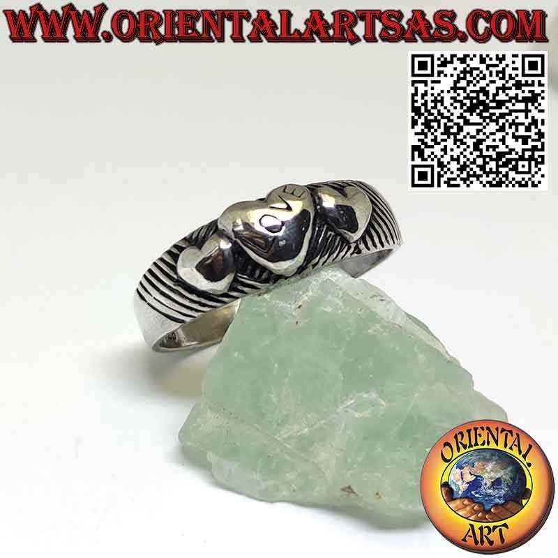 Silver ring with three hearts ascending and descending in high relief