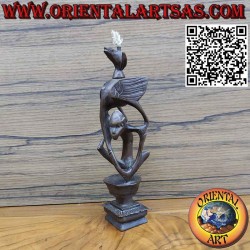 Rare ebony sculpture of a man, a pelican and an illuminated bat